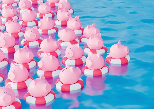Bunch of Piggy bank in lifebuoy on blue sea