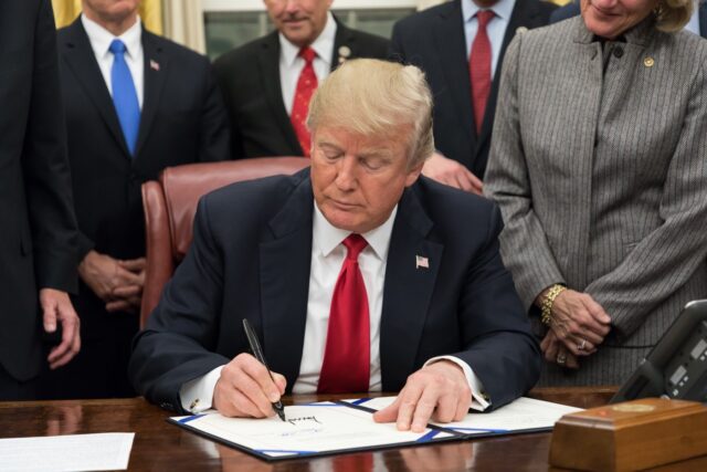 President Trump signing legislation at his desk